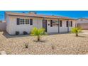 Well-maintained single-story home featuring desert landscaping, and an inviting covered entryway at 3249 E Nisbet Rd, Phoenix, AZ 85032