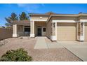 Inviting single-story home with a covered front porch and a two-car garage with desert landscaping at 3336 E Thornton Ave, Gilbert, AZ 85297