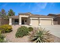 Well-maintained desert landscaping complements this single-story home with a two-car garage and covered porch at 3336 E Thornton Ave, Gilbert, AZ 85297