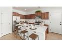 Bright kitchen featuring white countertops, stainless steel appliances, a center island with seating at 3467 S Falcon Dr, Gilbert, AZ 85297