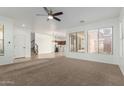 Spacious living room featuring neutral carpet, large windows, and an open layout with great natural light at 3467 S Falcon Dr, Gilbert, AZ 85297