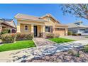 Lovely one-story home with manicured lawn, stone accents, a covered porch, and a tandem 3-car garage at 4342 E Ronald St, Gilbert, AZ 85295