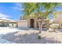 Lovely home with a spacious driveway, mature tree, and welcoming front porch at 45539 W Long Way, Maricopa, AZ 85139