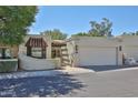 Charming front exterior with stucco and tile details, attached garage, and desert landscaping at 4705 E Winston Dr, Phoenix, AZ 85044