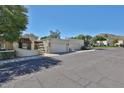 Street view of multiple homes with stucco and tile details, attached garages, and desert landscaping at 4705 E Winston Dr, Phoenix, AZ 85044