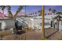 Exterior view of a well-maintained single-story home showcasing its surroundings and neighborhood appeal at 5055 E University Dr # G108, Mesa, AZ 85205