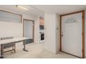 Clean entryway featuring tile floors, a front door, and an open doorway to the kitchen at 7844 N 17Th Ave, Phoenix, AZ 85021