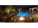 Beautiful outdoor oasis featuring a sparkling pool, spa, and a cozy fire pit area at 9422 E Southwind Ln, Scottsdale, AZ 85262