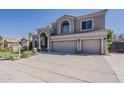 Stylish home featuring a three-car garage and desert landscaping in a sunny setting at 9535 E Los Lagos Vista Ave, Mesa, AZ 85209