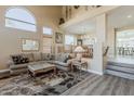 Spacious living room with soaring ceilings, large windows, and a comfortable seating area at 9535 E Los Lagos Vista Ave, Mesa, AZ 85209