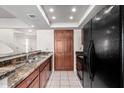 Kitchen with granite countertops, wood cabinets and modern appliances at 9705 E Mountain View Rd # 1064, Scottsdale, AZ 85258