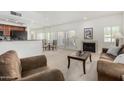 Open living room features a cozy fireplace and natural light at 9705 E Mountain View Rd # 1064, Scottsdale, AZ 85258