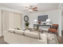Bright living room featuring a ceiling fan, modern furnishings, and large windows for natural light at 10610 S 48Th St # 1068, Phoenix, AZ 85044