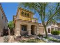 Two-story home features a stucco facade, two-car garage and covered porch with an arched entryway at 12030 W Polk St, Avondale, AZ 85323