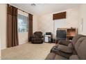 Cozy living room with neutral carpet, stone accent wall, and ample seating at 12030 W Polk St, Avondale, AZ 85323