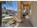 Covered porch features concrete flooring, stucco columns, and a seating area to enjoy the outdoors at 12030 W Polk St, Avondale, AZ 85323