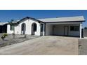 Single-story home with carport, xeriscaped front yard, and fresh white paint with black trim at 13202 N 40Th Pl, Phoenix, AZ 85032