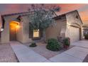 Inviting front entrance with a well-manicured lawn and a walkway leading to the front door at 15155 W Desert Hills Dr, Surprise, AZ 85379