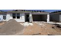 Image shows new home construction, exterior view, showing garage and building supplies at 15776 W Beryl Ave, Waddell, AZ 85355