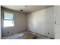 Image of an unfinished room showing drywall, window, and concrete floors at 15776 W Beryl Ave, Waddell, AZ 85355