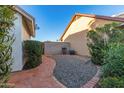 Paver patio area with gravel landscaping and mature shrubs at 1705 E Juanita Ave, Mesa, AZ 85204