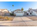 Traditional home with a two-car garage and desert landscaping under a clear blue sky at 1705 E Juanita Ave, Mesa, AZ 85204