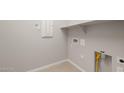 Functional laundry room with ample space, built-in shelving, and convenient utility connections at 17633 W Palo Verde Dr, Litchfield Park, AZ 85340
