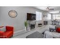 Inviting living room with stylish decor, a modern fireplace, wood-look floors, and neutral tones that create a welcoming atmosphere at 17988 W Deneen Way, Surprise, AZ 85374