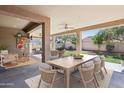 Spacious covered patio featuring outdoor dining and seating areas, perfect for relaxation and entertaining at 18061 W Post Dr, Surprise, AZ 85388
