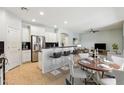Well-appointed kitchen with breakfast bar, stainless steel appliances, and seamless access to the living room at 18061 W Post Dr, Surprise, AZ 85388