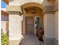 Welcoming entryway with an arched porch, decorative columns, and a stylish chandelier fixture at 1946 E Kings Ave, Phoenix, AZ 85022
