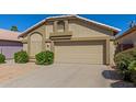 Attractive one-story home featuring a two-car garage, desert landscaping, and a well-maintained exterior at 1946 E Kings Ave, Phoenix, AZ 85022