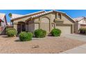 Inviting home exterior with a neutral color palette, manicured bushes, and a two-car garage at 1946 E Kings Ave, Phoenix, AZ 85022