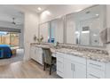 Elegant bathroom features dual vanities, granite countertops, and a well-lit vanity area with ample storage at 24270 N 173Rd Ave, Surprise, AZ 85387