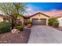 Charming single-story home featuring a well-manicured front yard and a spacious two-car garage at 2550 W Pumpkin Ridge Dr, Anthem, AZ 85086