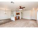 Open-concept living space with carpet, tile, and kitchen island with breakfast bar seating at 2624 E La Costa Dr, Chandler, AZ 85249