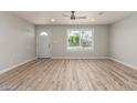 Bright living room featuring wood-look flooring and a large window at 2634 N 52Nd Ave, Phoenix, AZ 85035