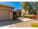 Close-up of a home's desert landscaping and stone entrance providing curb appeal at 29374 N 68Th Ln, Peoria, AZ 85383