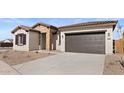 Lovely home featuring stone accents and a spacious two-car garage at 37650 W Nina St, Maricopa, AZ 85138