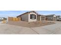 View of a home with desert landscaping and a wooden fence at 37650 W Nina St, Maricopa, AZ 85138