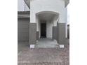 Inviting front entrance with a covered porch, stone pillars, and a beautiful wood front door at 43372 N Wollemi St, Queen Creek, AZ 85140