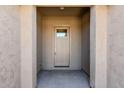 Neutral toned entryway with glass paneled front door and textured wall finish at 4557 W South Butte Rd, San Tan Valley, AZ 85144