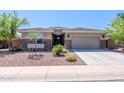 Charming single-story home with a two-car garage and low-maintenance desert landscaping at 4557 W South Butte Rd, San Tan Valley, AZ 85144