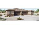 Charming single-story home with a neutral color scheme, attached two-car garage, and low maintenance desert landscaping at 5633 N 205Th Ln, Buckeye, AZ 85396