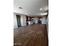 Open concept living space with wood-look tile, recessed lighting, and modern kitchen at 5633 N 205Th Ln, Buckeye, AZ 85396