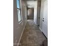 Hallway with recessed lights, windows, and white doors at 5641 N 205Th Ln, Buckeye, AZ 85396