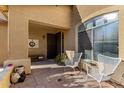 Inviting front porch with seating, decor, and a view of the front door and a large window at 6506 W Bent Tree Dr, Phoenix, AZ 85083