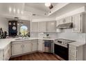 Bright kitchen with stainless steel appliances, white countertops, and a modern backsplash at 6520 E Sugarloaf St, Mesa, AZ 85215