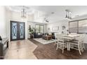 Bright living room with modern chandelier, decorative ceiling, and a stylish dining area at 69 E Benrich Dr, Gilbert, AZ 85295
