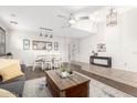 Spacious living area with a neutral color palette, tile flooring, and modern ceiling fan at 69 E Benrich Dr, Gilbert, AZ 85295